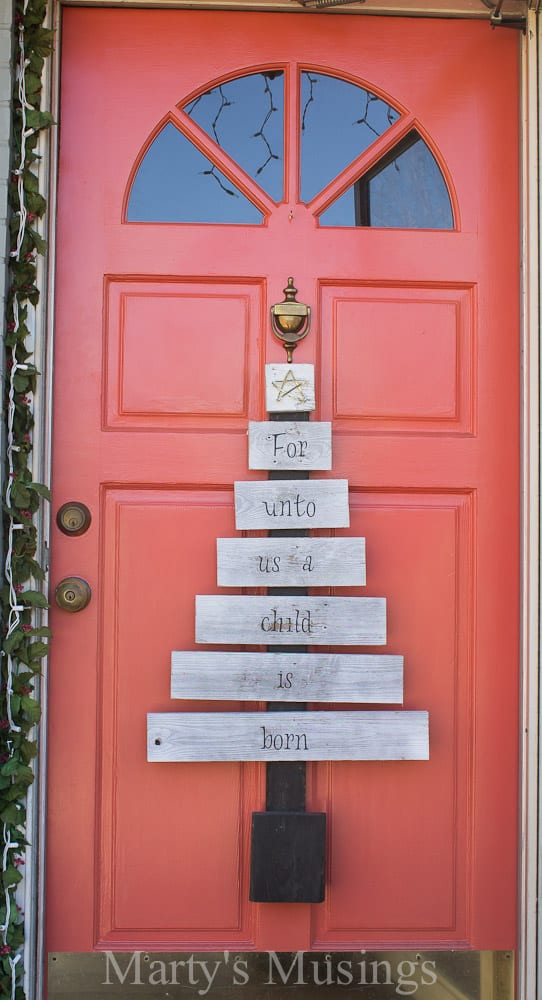 Want unique repurposed holiday decor you can make yourself? This creative scrap wood Christmas tree is made from old fence boards with vinyl letters