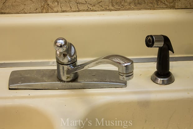 A sink sitting under a mirror