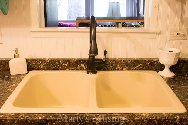 A sink sitting under a window