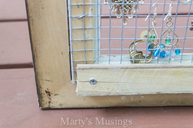 This DIY framed jewelry and earring organizer from Marty's Musings is created inexpensively from a yardsale frame and chicken wire. Perfect for hanging necklaces or earrings.