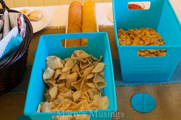 A box filled with different types of food on a table, with Shower and Party
