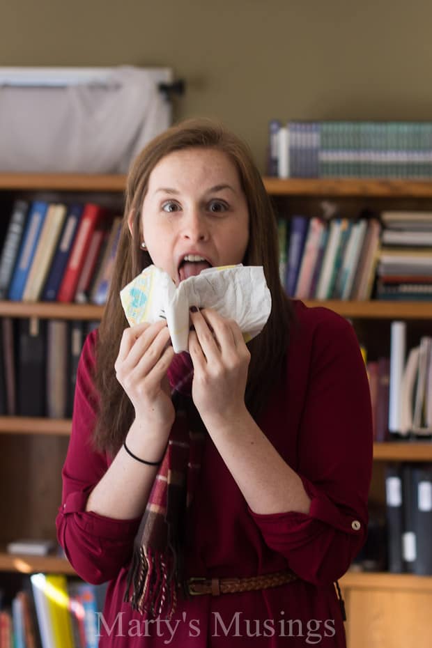 A girl holding a book shelf