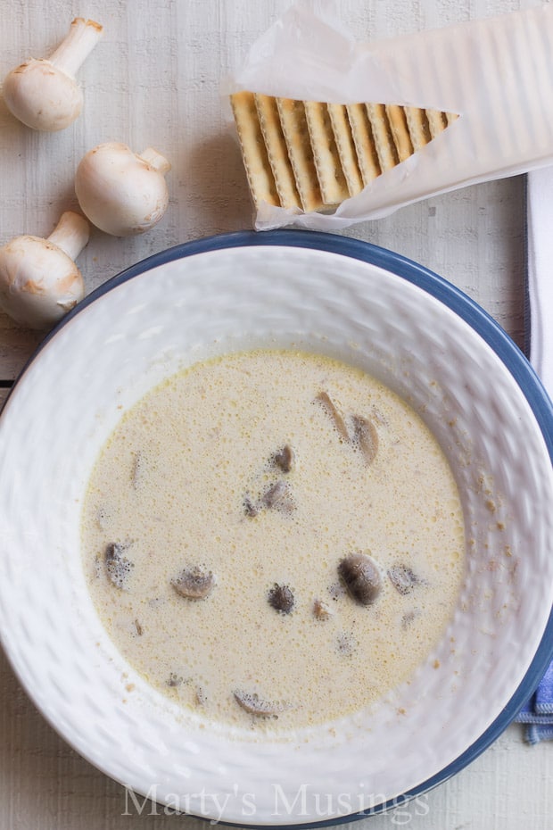 A bowl of food on a plate, with Cooker and Soup