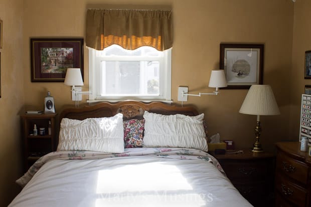 A bedroom with a bed and desk in a hotel room