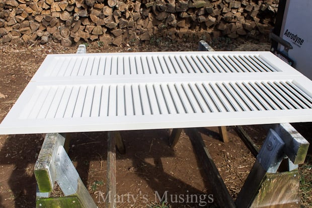 A stone bench sitting on top of a wooden fence