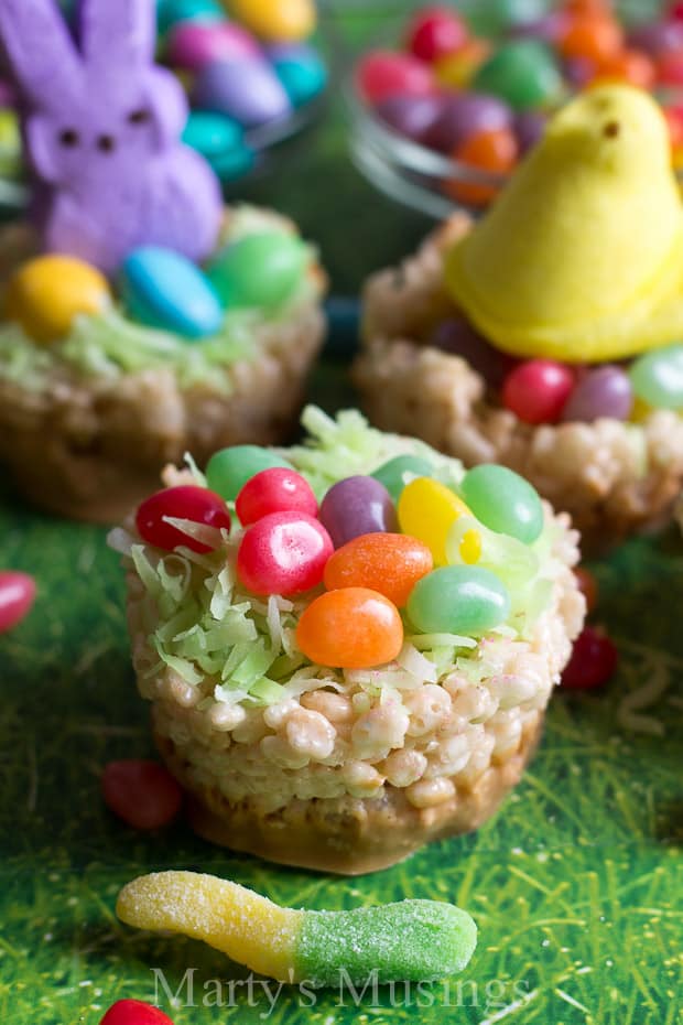 A cake with fruit on top of a grass covered field