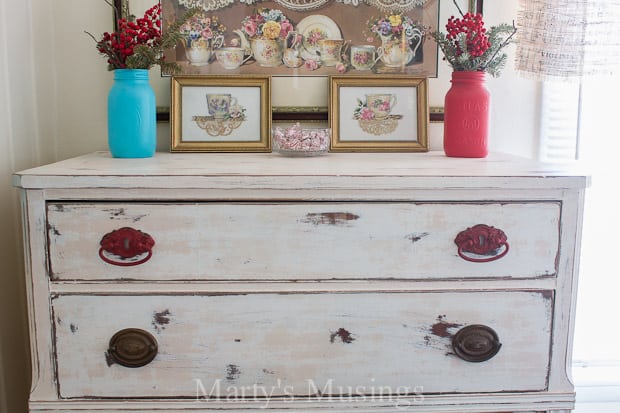 White distressed cabinet with red and blue accessories