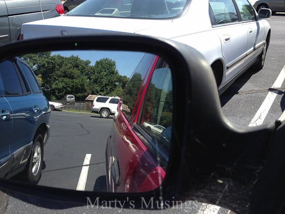 A car parked in front of a mirror posing for the camera