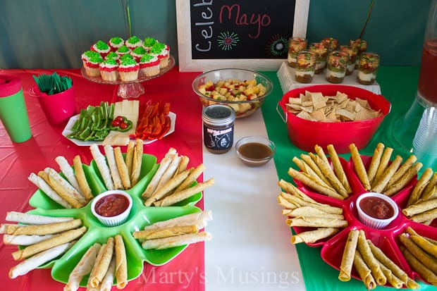 Fun ideas for throwing a themed Cinco de Mayo party on a budget with inexpensive decorations and easy recipes including pineapple salsa and taquitos.