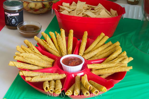 Fun ideas for throwing a themed Cinco de Mayo party on a budget with inexpensive decorations and easy recipes including pineapple salsa and taquitos.