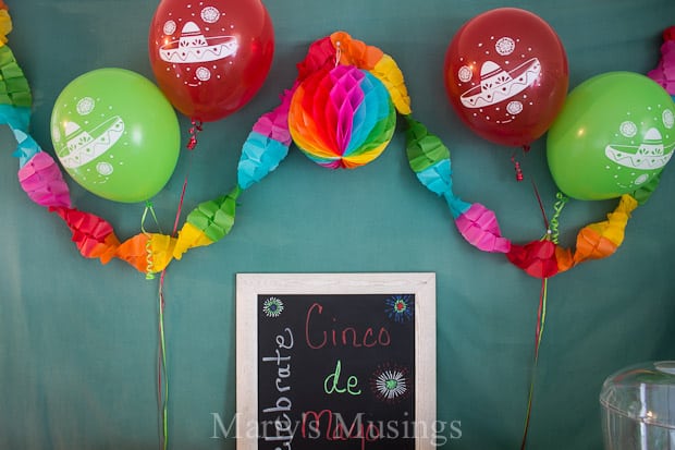 Green and red balloons and colorful banner for Cinco de Mayo