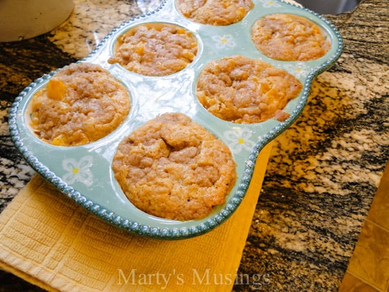 A bowl of food on a table, with Peach and Cobbler