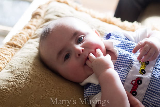 A baby lying on a bed