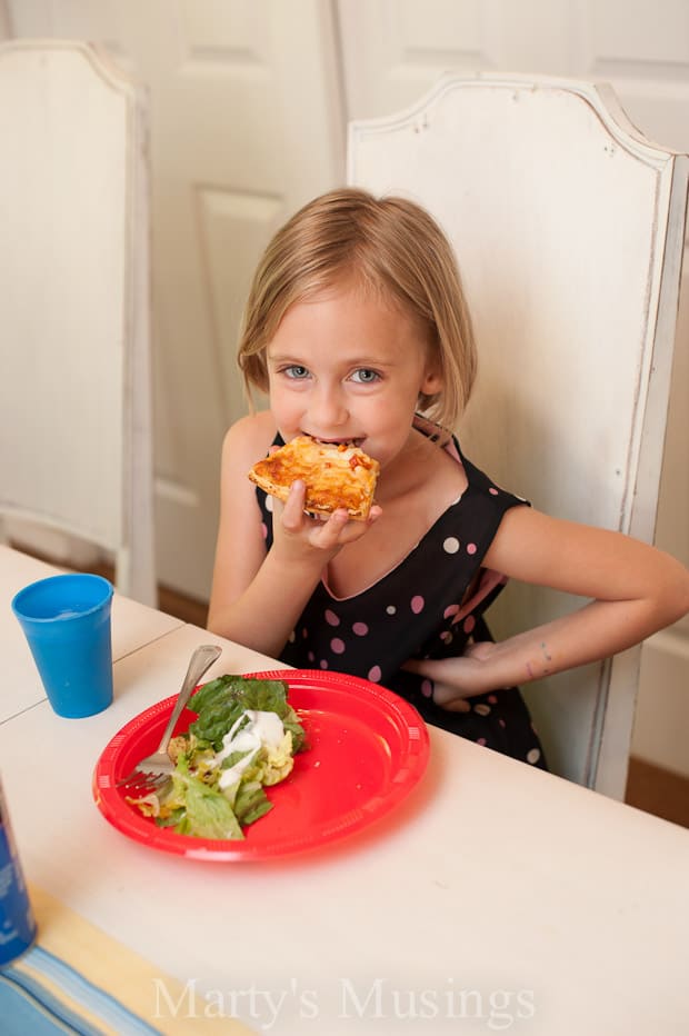 A woman sitting at a table with a plate of food