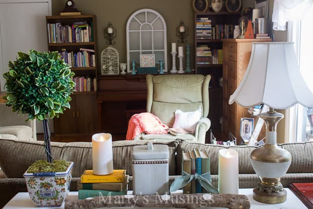 A living room filled with furniture and vase of flowers on a table