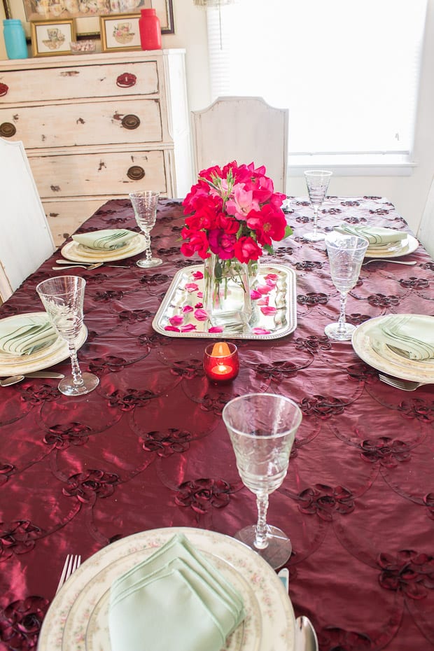 A dining table with wine glasses, with Tablecloth and Linen