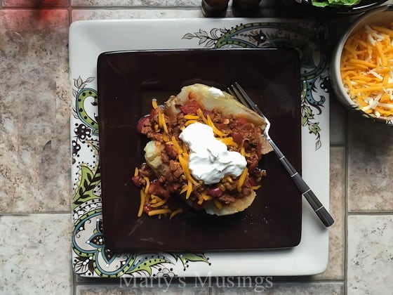 A tray of food on a table, with Baked potato and Cheese