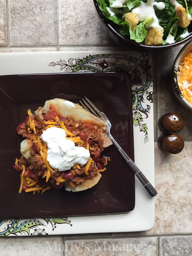 A tray of food on a table, with Baked potato and Slow cooker