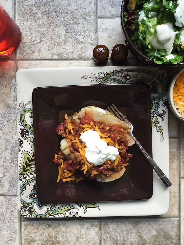 A tray of food on a table, with Baked potato