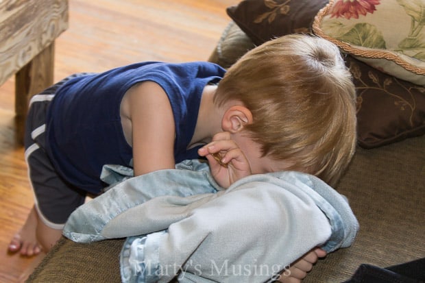 A little boy is lying on the floor