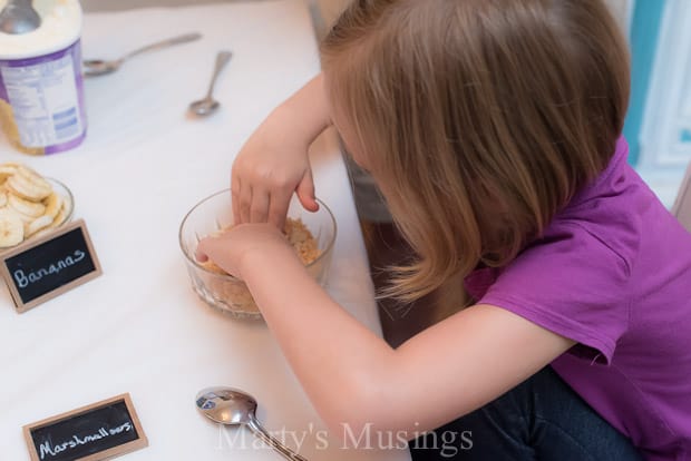 A little girl sitting at a table