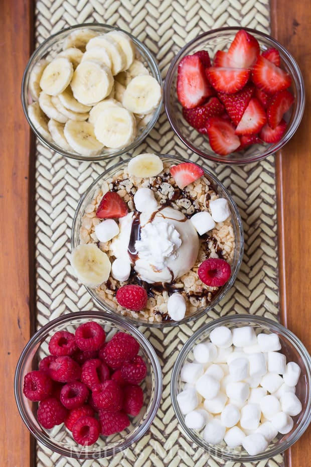 A bowl of fruit on a plate, with Cream and Rice Krispies