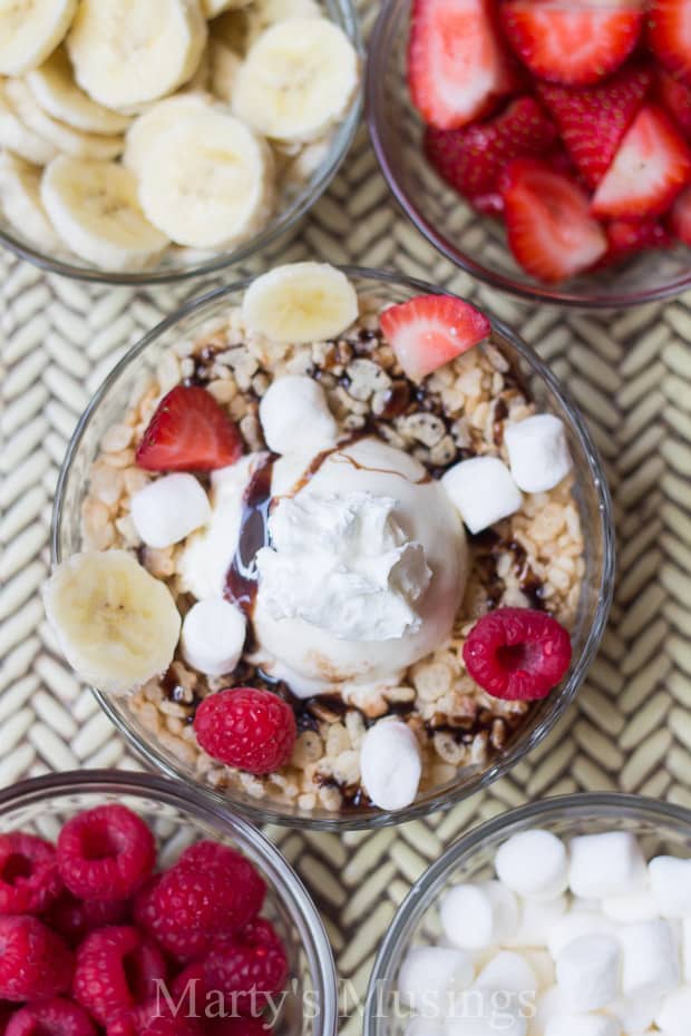 A bowl of fruit on a plate, with Rice Krispies and Ice cream