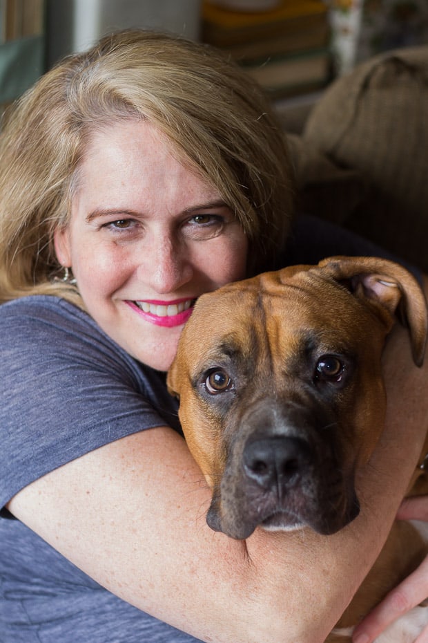 A woman and a dog posing for the camera