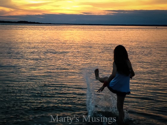 A person standing next to a body of water