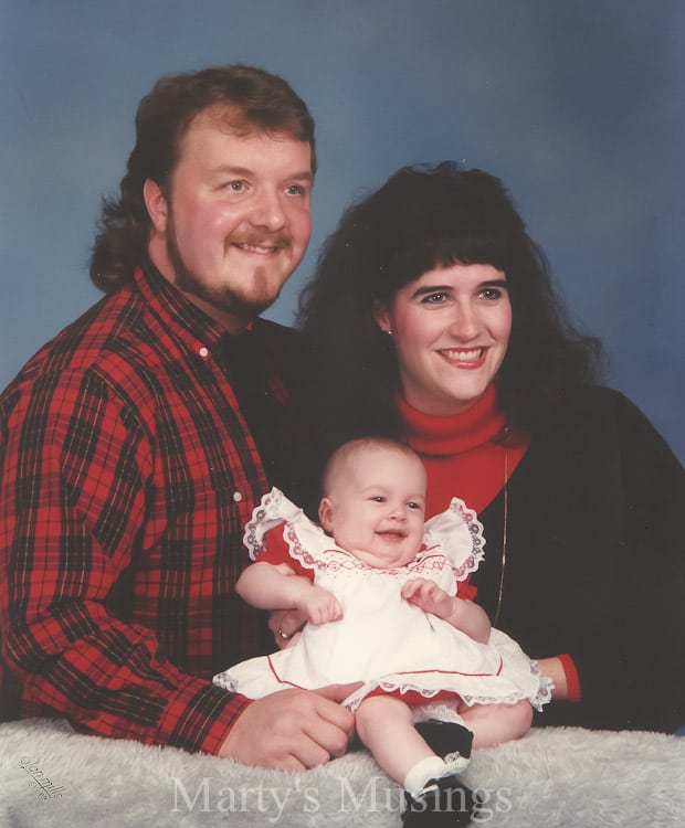 A man and a woman holding a baby