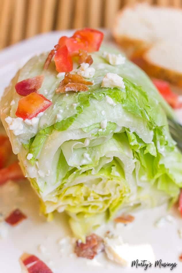 A close up of a plate of food, with Salad and Blue cheese dressing