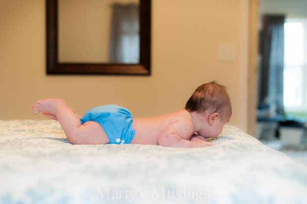 A baby lying on a bed