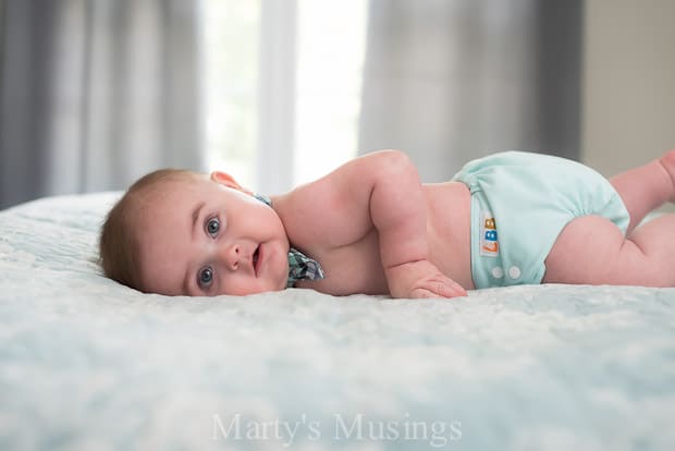 A baby lying on a bed