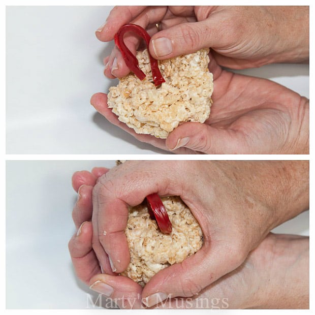 A person holding a piece of food, with Ornament and Rice Krispies