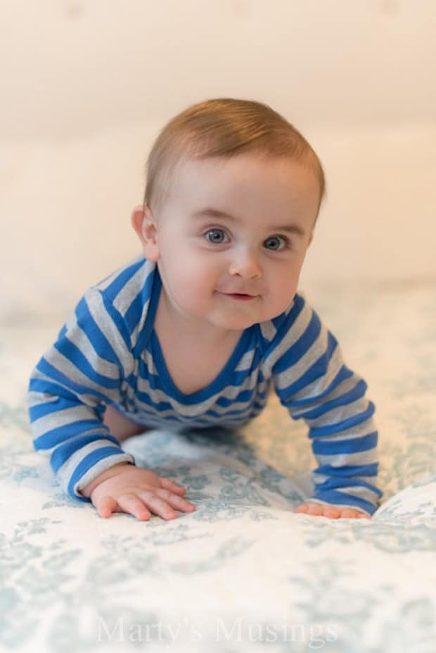 A young boy holding a baby