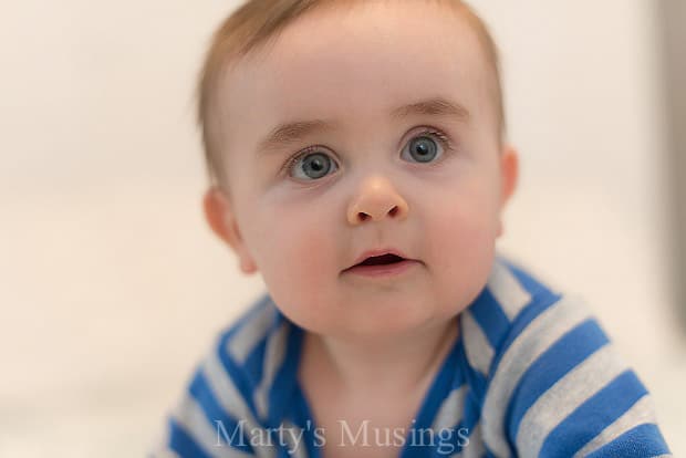 A close up of a boy in a blue shirt