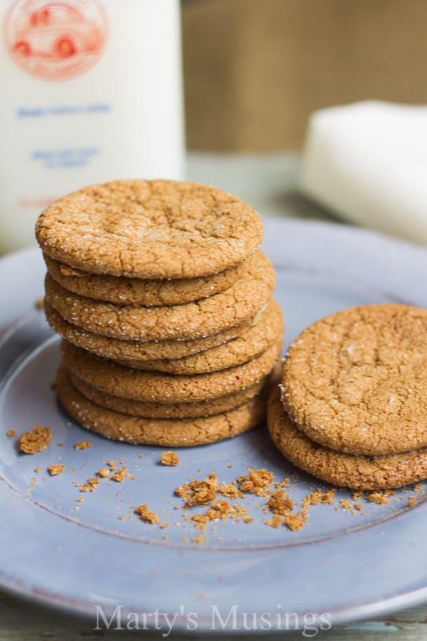 Molasses cookies on top of blue plate with milk