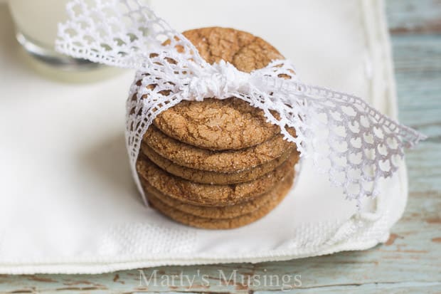 Molasses cookies on white napkins with ribbon around them