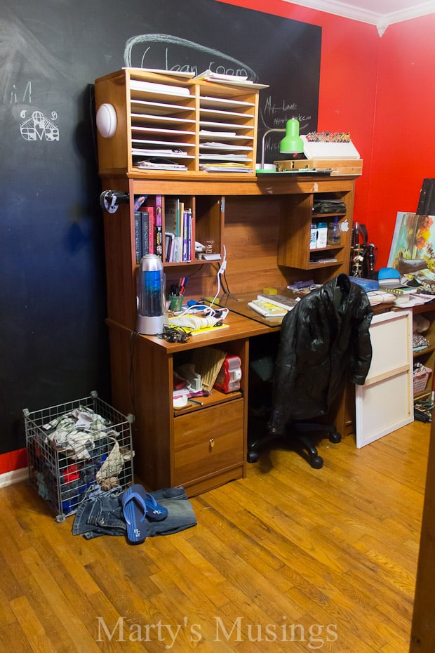 Black chalkboard wall with red wall and boy's messy room