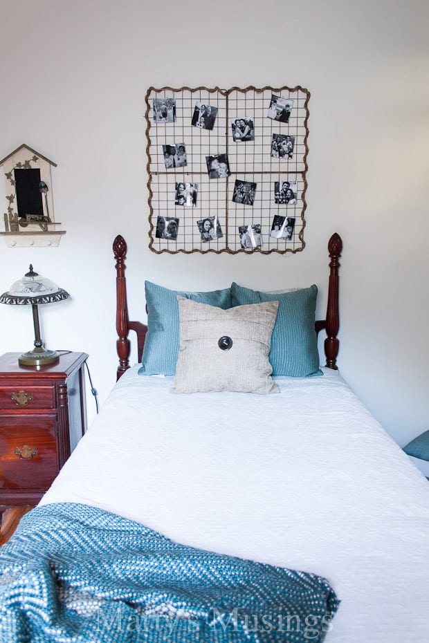 White walls with photos and vintage bed