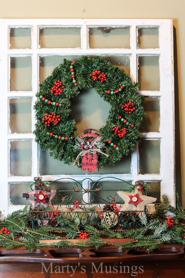 A christmas tree sits in front of a window