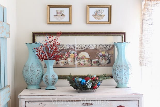 A vase of flowers next to a fireplace