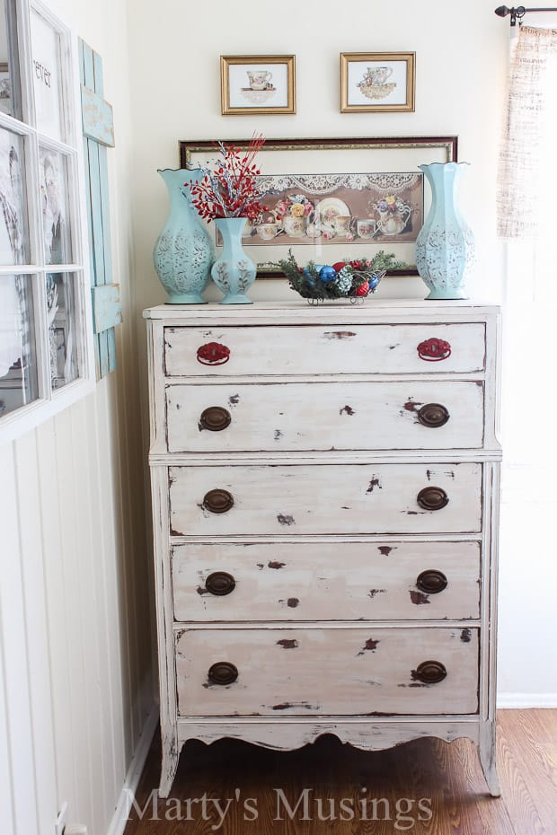 A bedroom with a bed and desk in a small room