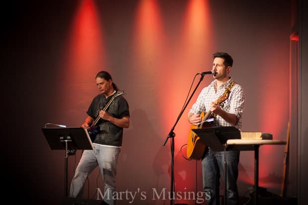 A couple of people that are standing in front of a stage