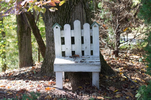 A wooden bench sitting next to a tree