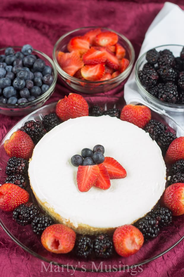 A table topped with different types of food on a plate, with Fruit and Cream