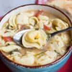 A bowl of food, with Cheese and Soup