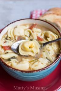 A bowl of food, with Cheese and Soup