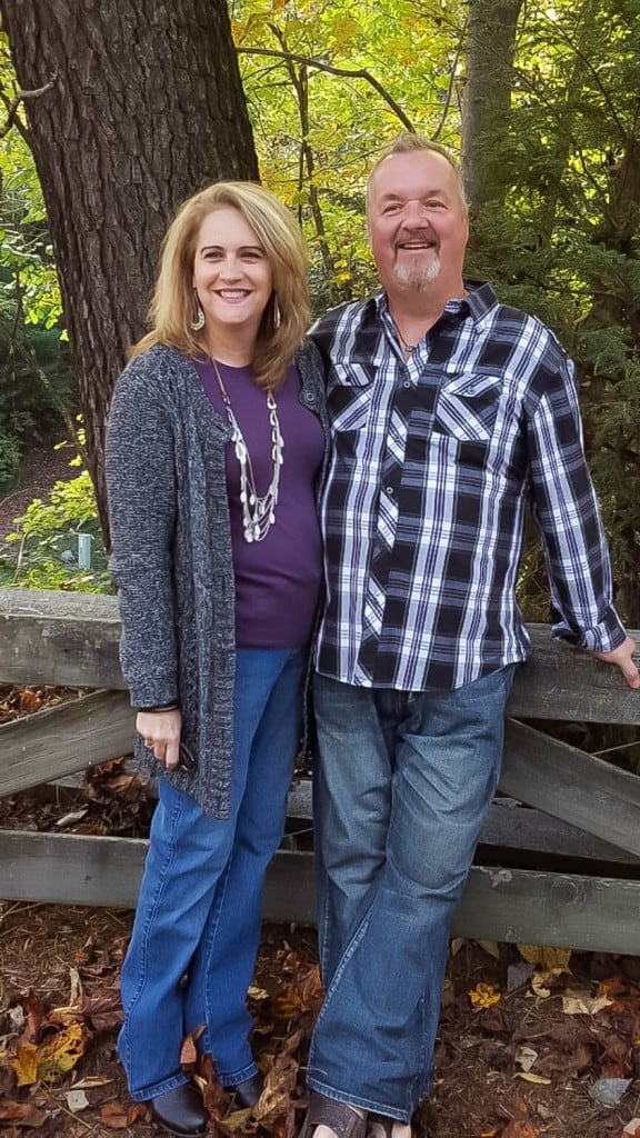 A man and a woman standing in a park, with Valentine's Day