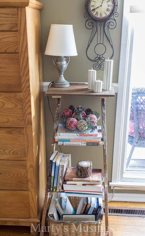 A trash to treasure Step Ladder Shelf makes the perfect side table in this shabby chic home filled with rustic repurposed treasures and budget DIY projects.